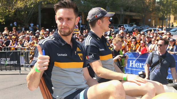 Jack Gunston of the Hawks waves to the crowd during the grand final parade.