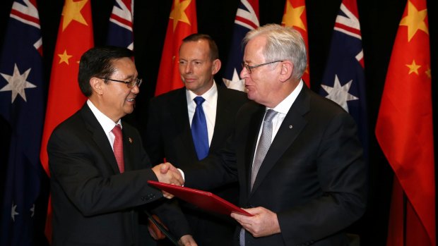 Chinese Commerce Minister Gao Hucheng, former prime minister Tony Abbott and then trade minister Andrew Robb at the signing of the China-Australia free trade agreement in June 2015. 