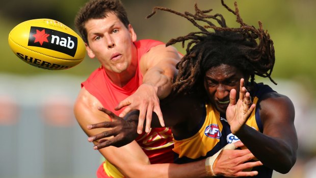 Daniel Currie of the Suns and Nic Naitanui of the Eagles contest the ruck.