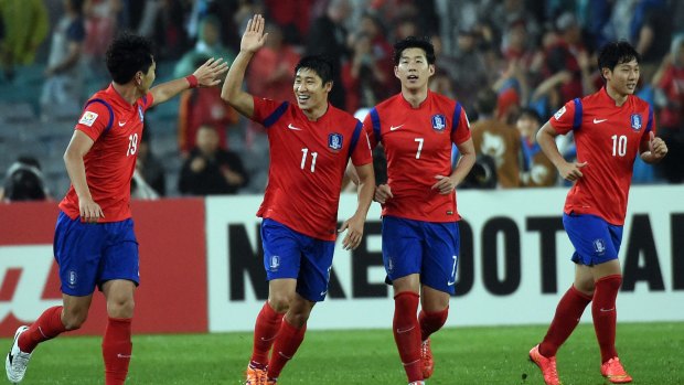 Final bound: South Korea's Lee Keun Ho celebrates with Kim Young Gwon (left) after his goal against Iraq. 