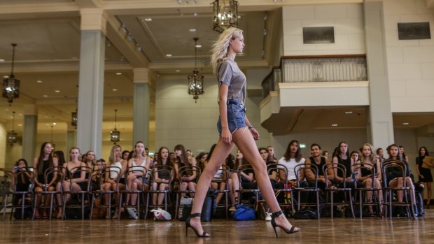 A model walks in front of other hopefuls at the casting for the David Jones Autumn Winter 2016 Fashion Launch runway show. 