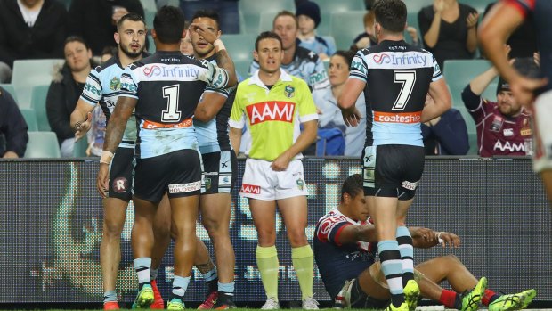 Bird flies past Roosters: Jack Bird celebrates with his Sharks teammates after scoring a try.