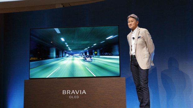 Kazuo Hirai, president and chief executive of Sony, stands next to a Sony XBR-A1E Bravia OLED 4K HDR.