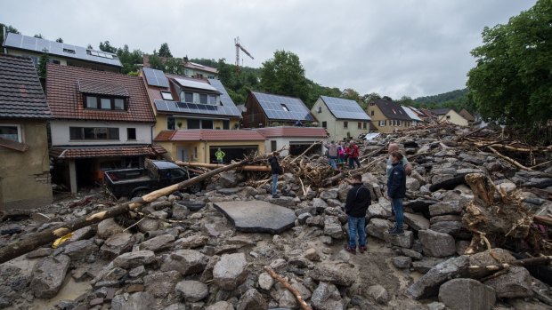 People inspect the damage in Braunsbach after a night of storms in southern Germany.
