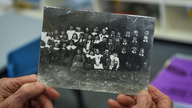 Precious memento: Margaret Hanrahan holds a class photo of St Michael's primary school - then called Ormond Catholic School - from around 1912 including her father Tom Kennedy, second row far right. 
