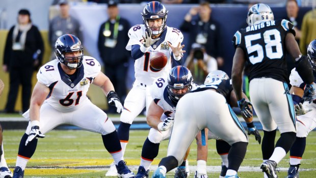 Peyton Manning, centre, in action for the Denver Broncos against the Carolina Panthers.
