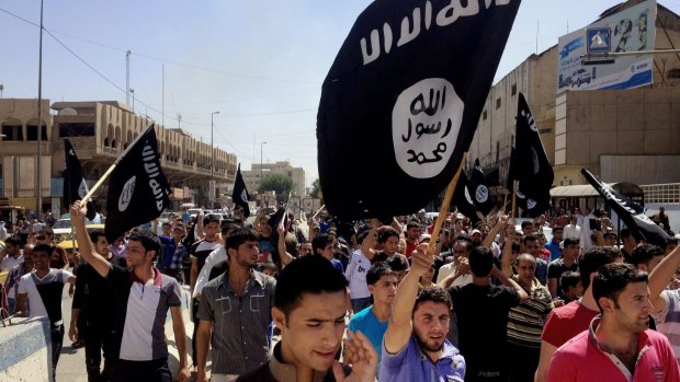 Demonstrators chant pro-Islamic State group slogans in Mosul, Iraq in 2014.