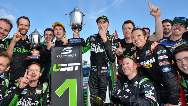First at last: Mark Winterbottom (centre) and his  team celebrate their first win of the season. 