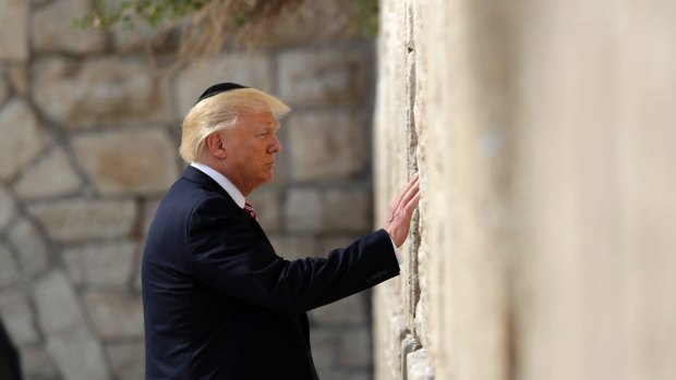 Donald Trump touches the Western Wall in the Israeli-occupied Old City of Jerusalem during his visit in May. Like his Jerusalem policy, that trip broke decades of diplomatic precedent.