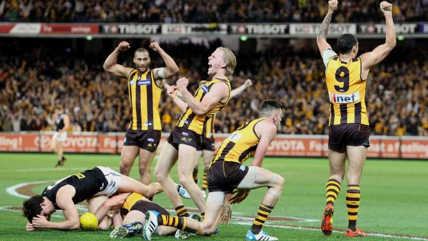 Hawthorn players celebrate on the final siren, having beaten Port Adelaide in the preliminary final.