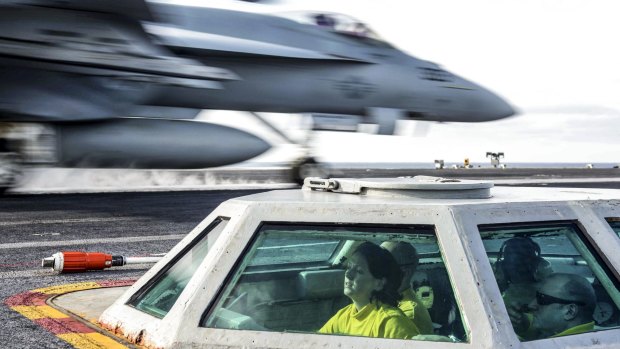 Here to stay: US Navy Lt. Michelle Mayer launches an F/A-18C Hornet from the bubble on the flight deck of the USS John C. Stennis in the Western Pacific.