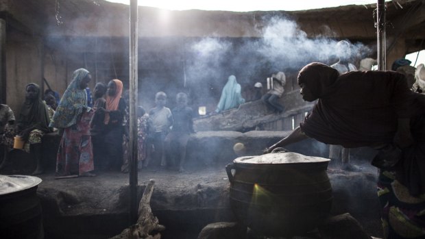 A woman prepares food at the children's kitchen at the Dalori Internally Displaced Persons Camp in Maiduguri, Nigeria. 