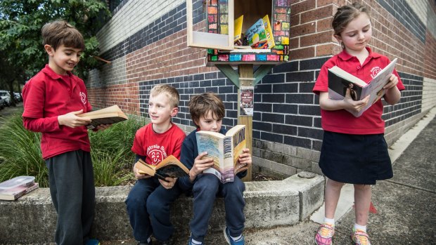 Students from Australia Street Infant School taking books from their Street Library.