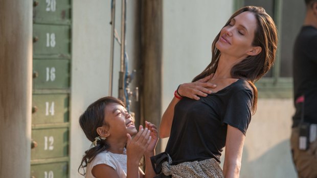 Angelina Jolie (right) with Sareum Srey Moch as a young Loung Ung during the film shoot. Jolie says going to Cambodia opened her eyes to camps and refugees.