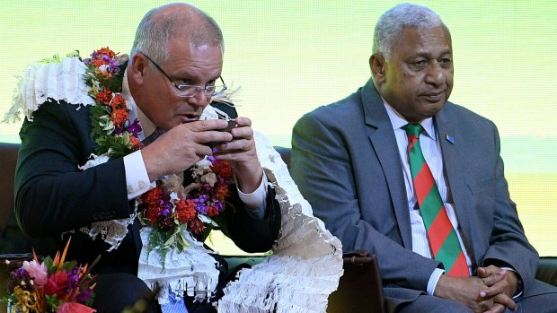 Scott Morrison attends a traditional ceremony of welcome with the Prime Minister of Fiji Frank Bainimarama in Suva.