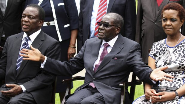 Zimbabwe's President Robert Mugabe, centre,  with his wife Grace Mugabe and Emmerson Mnangagwa, the new vice-president.