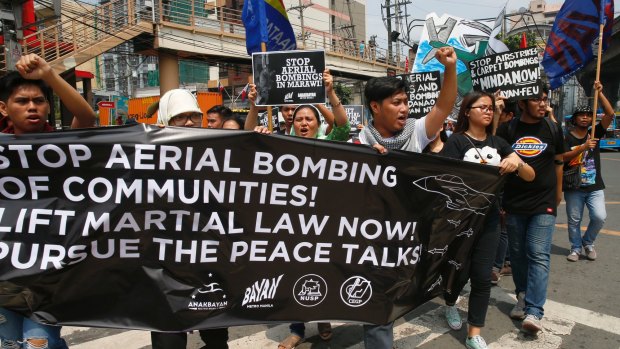 Protesters call for an end to bombing in Marawi during a rally in Manila.