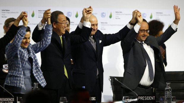 United Nations climate change chief Christiana Figueres, left, UN Secretary-General Ban Ki-moon, French Foreign Affairs Minister and UN Climate Change Conference in Paris president Laurent Fabius and French President Franois Hollande celebrate an agreement on climate change.
