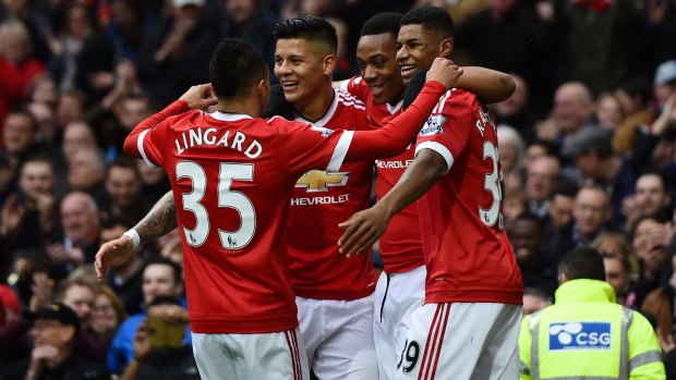 Party poopers: Manchester United celebrate after Anthony Martial's goal. 