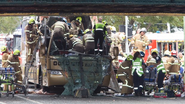 Firefighters work to free trapped passengers.