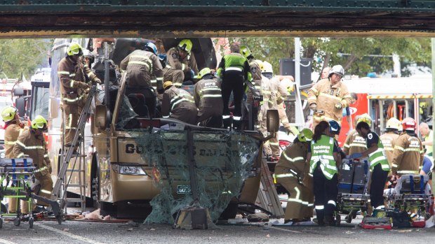 Firefighters work to free trapped passengers.