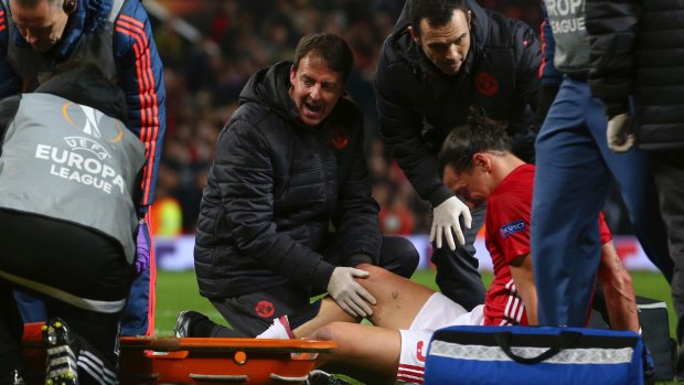Manchester United's Zlatan Ibrahimovic is checked before being taken off with an injury.