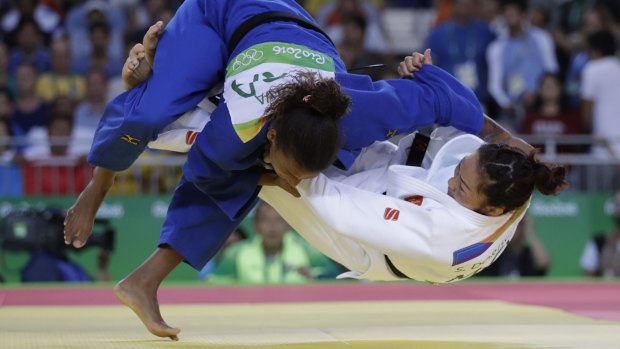 Brazil's Rafaela Silva in blue competes with Mongolia's Sumiya Dorjsuren for the gold medal.