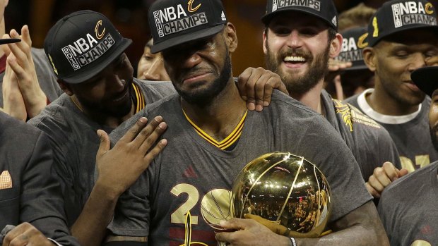 Emotional: LeBron James tears up as the Cavaliers receive the Larry O'Brien trophy.