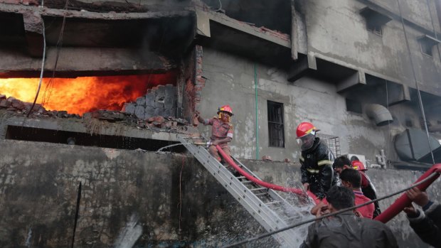 Firefighters work to put out the fire at a packaging factory in Tongi industy area outside Dhaka, Bangladesh.