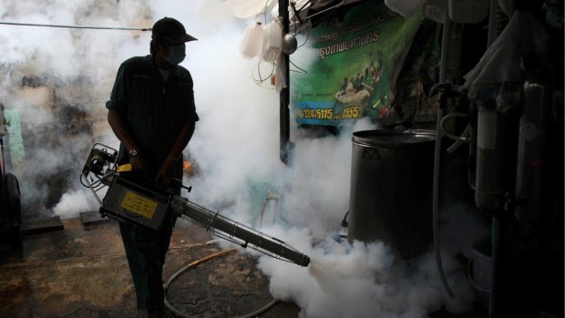 A government worker fogs a home with mosquito repellent in Thailand where authorities confirmed two babies were born with Zika-related birth defects.