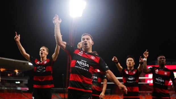 Historic win: Brendon Santalab leads the Wanderers players over to Western Sydney fans after their 2-1 win on Sunday.