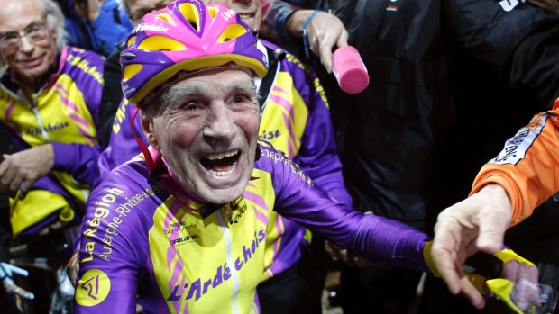 French cyclist Robert Marchand, 105, reacts after setting a record for distance cycled in one hour.