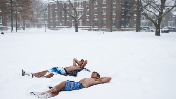  Students lie in their bathing suits on the Quad, on the campus of Harvard University in Cambridge, Massachusetts. Boston and much of the US Northeast were hit with heavy snow from Winter Storm Juno.