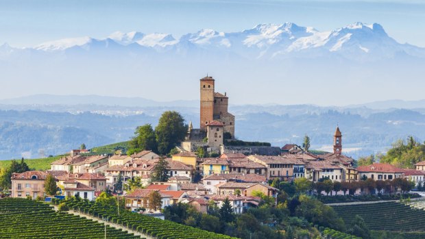 Serralunga d'Alba, a hill town in the Langhe, Piedmont, Italy, with the Alps behind.