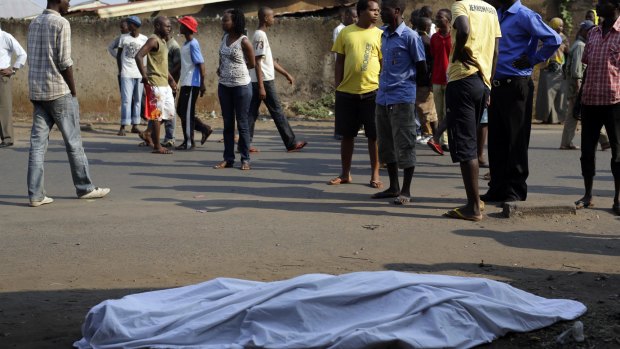 The body of a man lies on a street in Bujumbura as polls open.