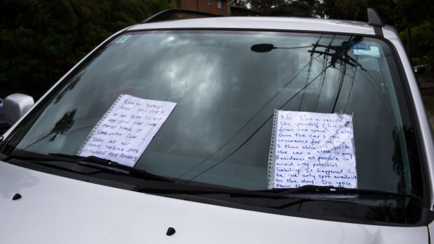 An exchange of notes left on a car parked on the side of the road in a completely legal spot indicates the rising level of frustration in the search for on-street parking.