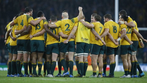Australia players gather after the Rugby World Cup quarterfinal win over Scotland. 