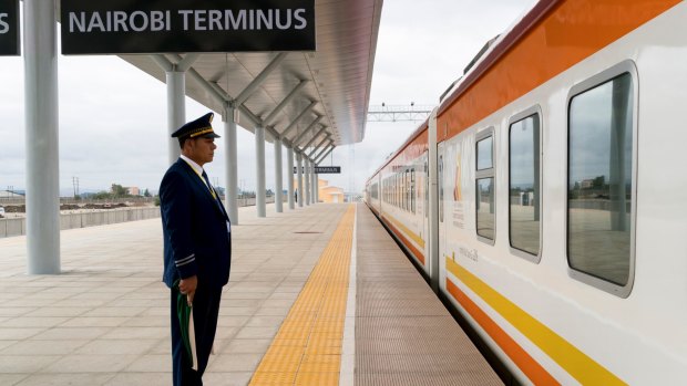 A Kenya Railways employee sends off the train from Nairobi to Mombasa at the new Standard Gauge Railway terminal in Nairobi.