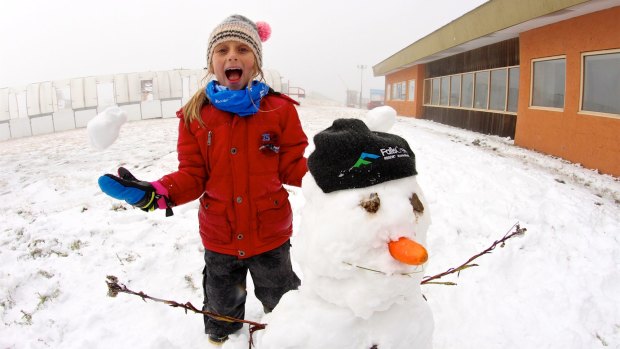 Jacinta Jansen, 7, with her first snowman for the year at Falls Creek.
