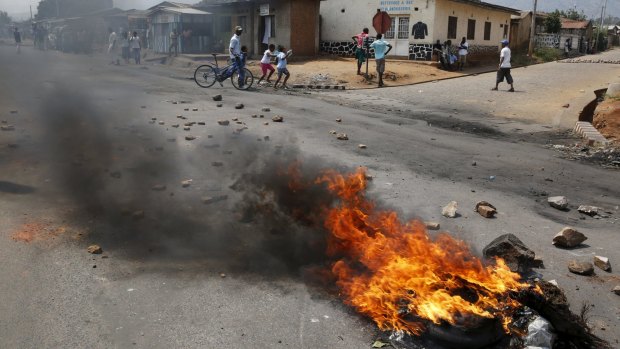 Unrest: A barricade burns on a rock strewn street in Bujumbura's Niyakabiga district on election day.
