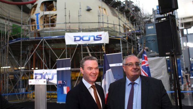 Naval Group chief executive Herve Guillou, right, at the firm's shipyards in Cherbourg, France, with Minister for Defence Industry Christopher Pyne.