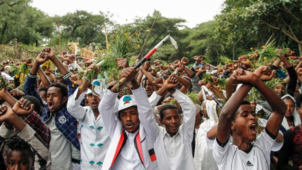 Ethiopians chant slogans against the government during their march in Bishoftu, Ethiopia.