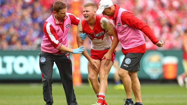 Cruel injury: Dan Hannebery leaves the field during the grand final.