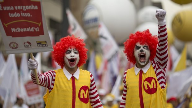 Demonstrators dressed as Ronald McDonald protest for better wages for McDonald's employees in Sao Paulo, Brazil. 