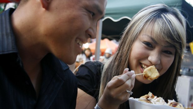 Visitors tuck into Chinatown street food. 