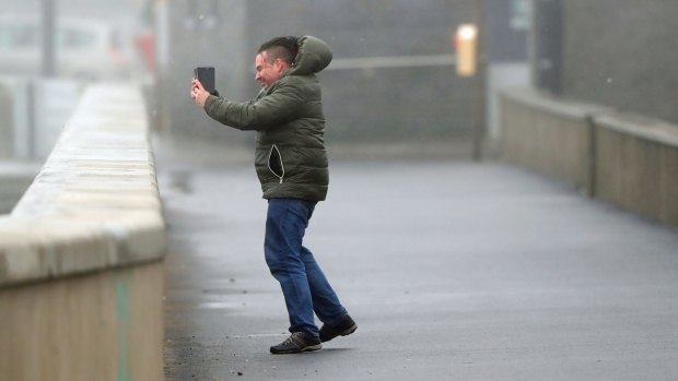 A man takes a selfie at Lahinch, on the west coast of Ireland, as the remnants of Hurricane Ophelia hit. 