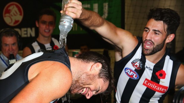 Jeremy Howe and Alex Fasolo celebrate in the rooms after the game.