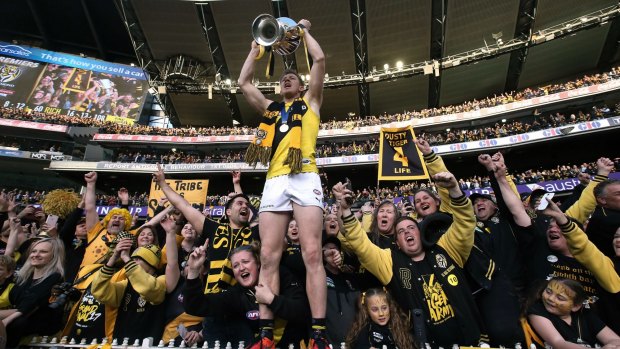 Jack Riewoldt celebrates Richmond's premiership with the Tigers' cheer squad.