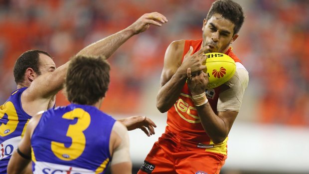 GOLD COAST, AUSTRALIA - AUGUST 01:  Jack Martin of the Suns takes a mark during the round 18 AFL match between the Gold Coast Suns and the West Coast Eagles at Metricon Stadium on August 1, 2015 in Gold Coast, Australia.  (Photo by Chris Hyde/Getty Images)