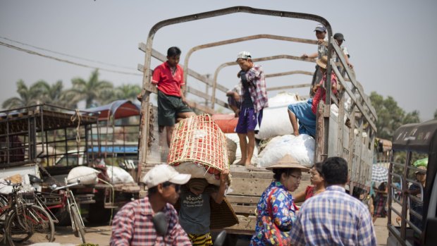 Workers load goods onto truck Danyingon Railway Market.